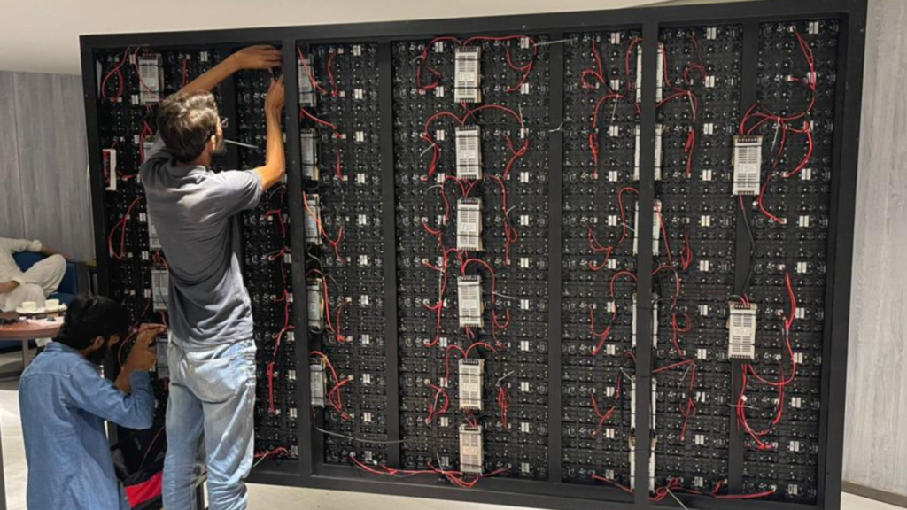 A man is fixing a problem in LED Displays. While the picture shows the inner structure of the LED Screen